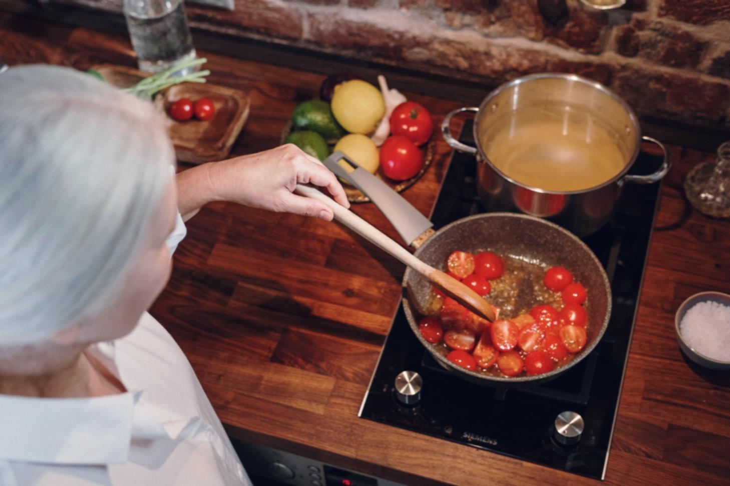 Chef demonstrating seasonal ingredient preparation technique